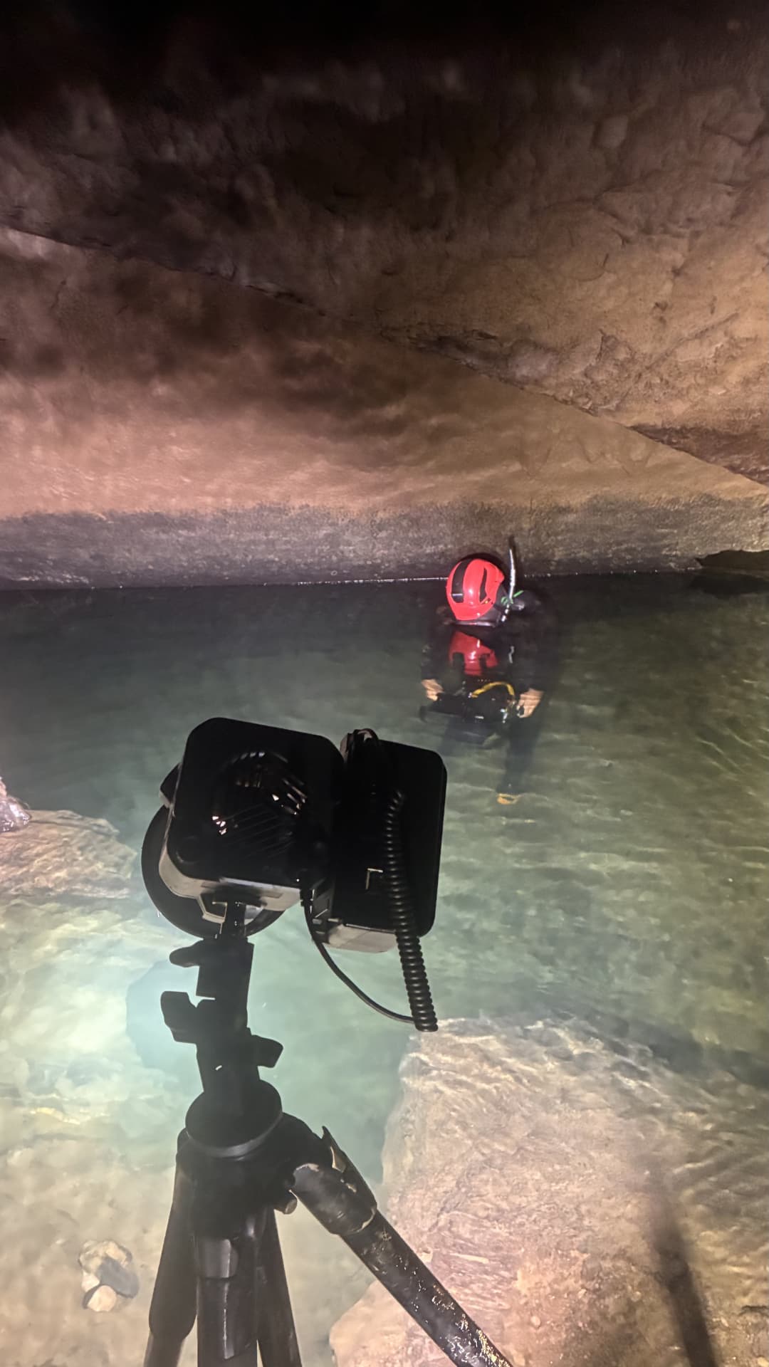 Diver filming underwater inside the cave