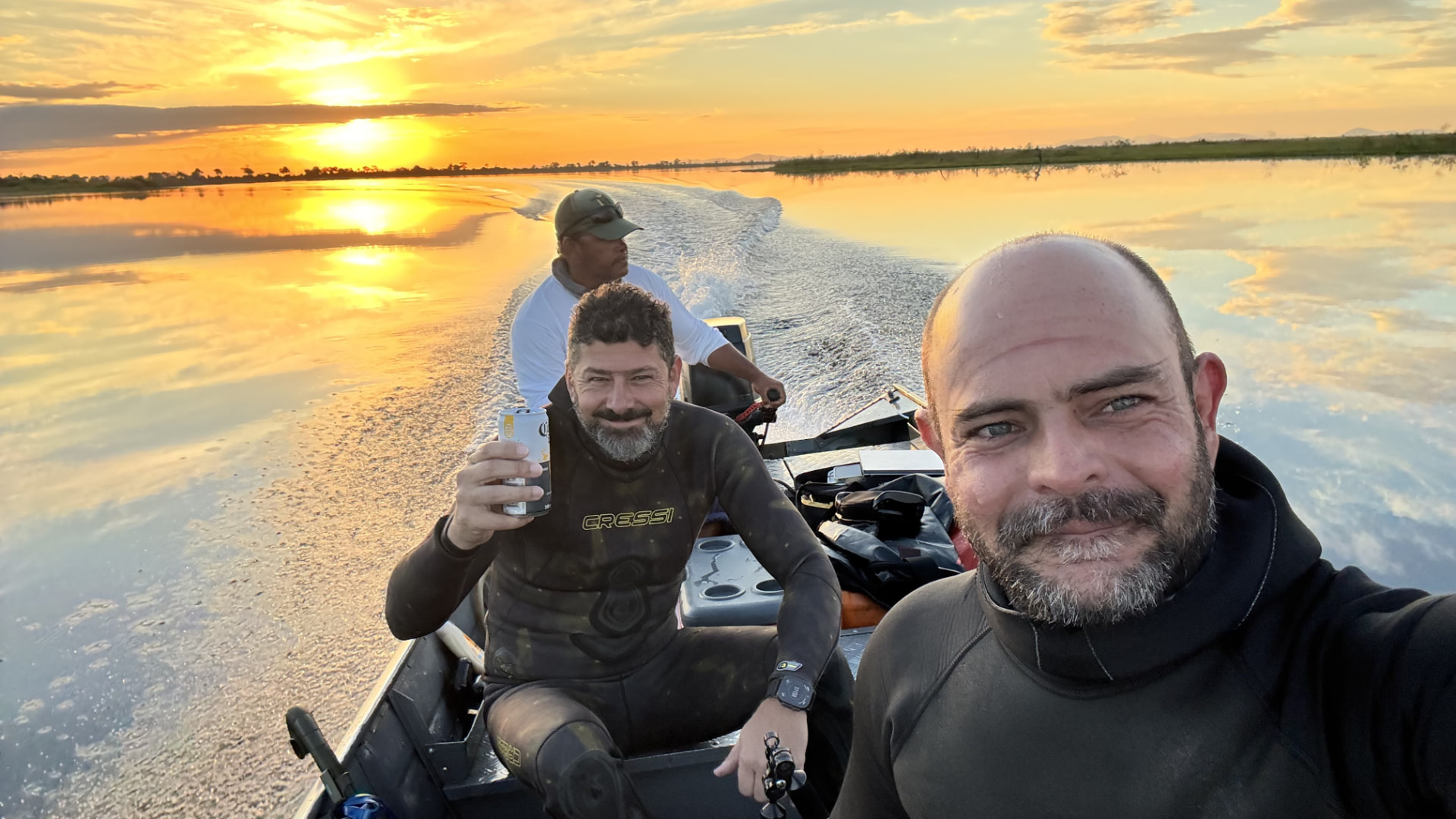 Expedition team on a boat at sunset in the Pantanal
